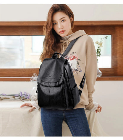 Black leather backpack worn