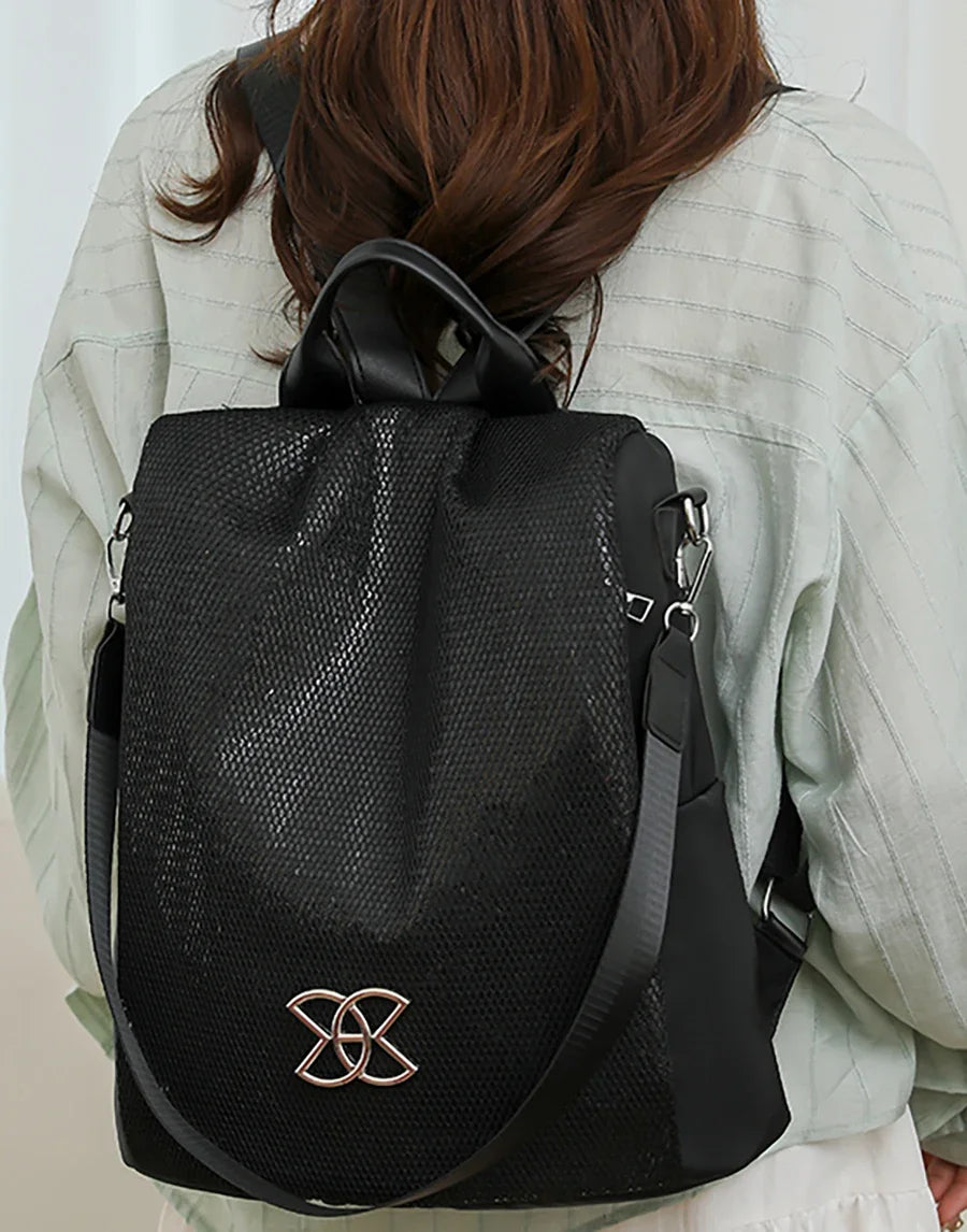 Black backpack worn on the back