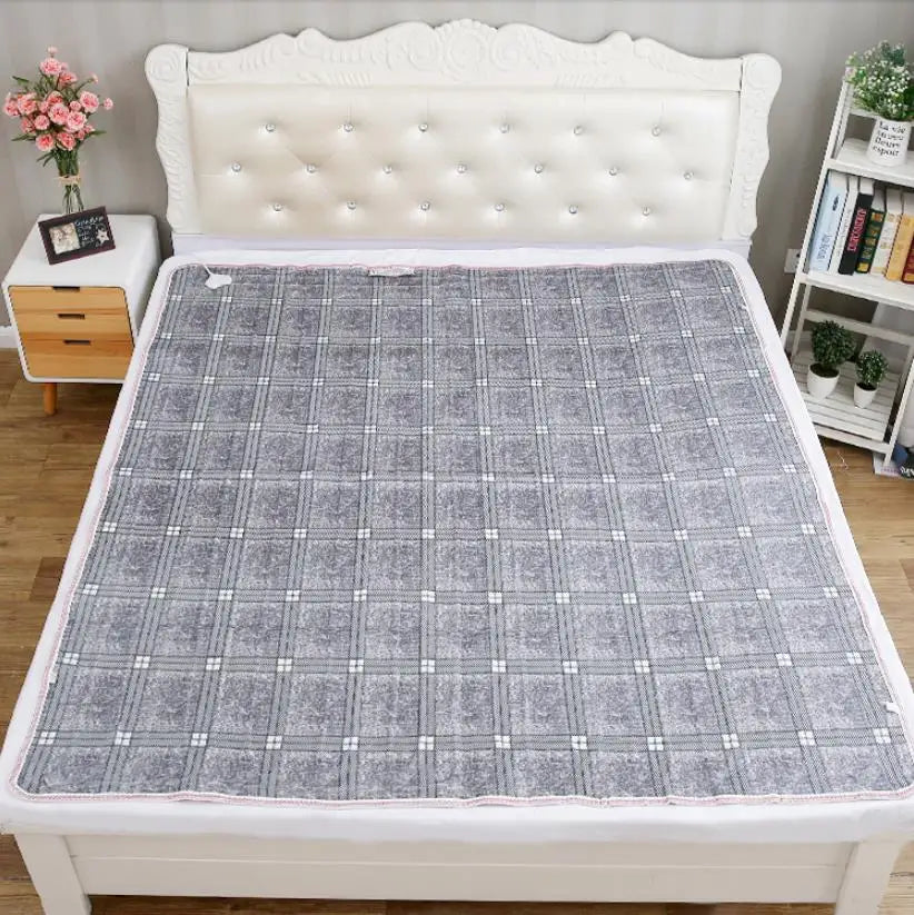 Gray electric blanket on a bed