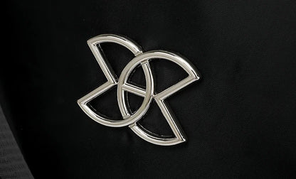 Metal emblem detail on the backpack