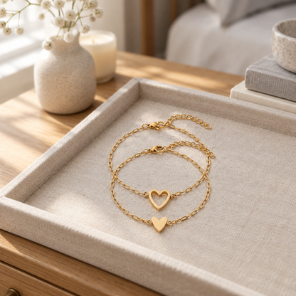 Matching heart chain bracelets on a linen tray