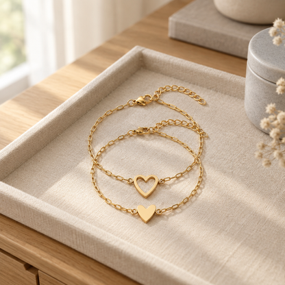 Matching heart chain bracelets on a linen tray