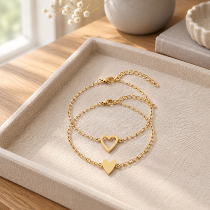 Matching heart chain bracelets on a linen tray